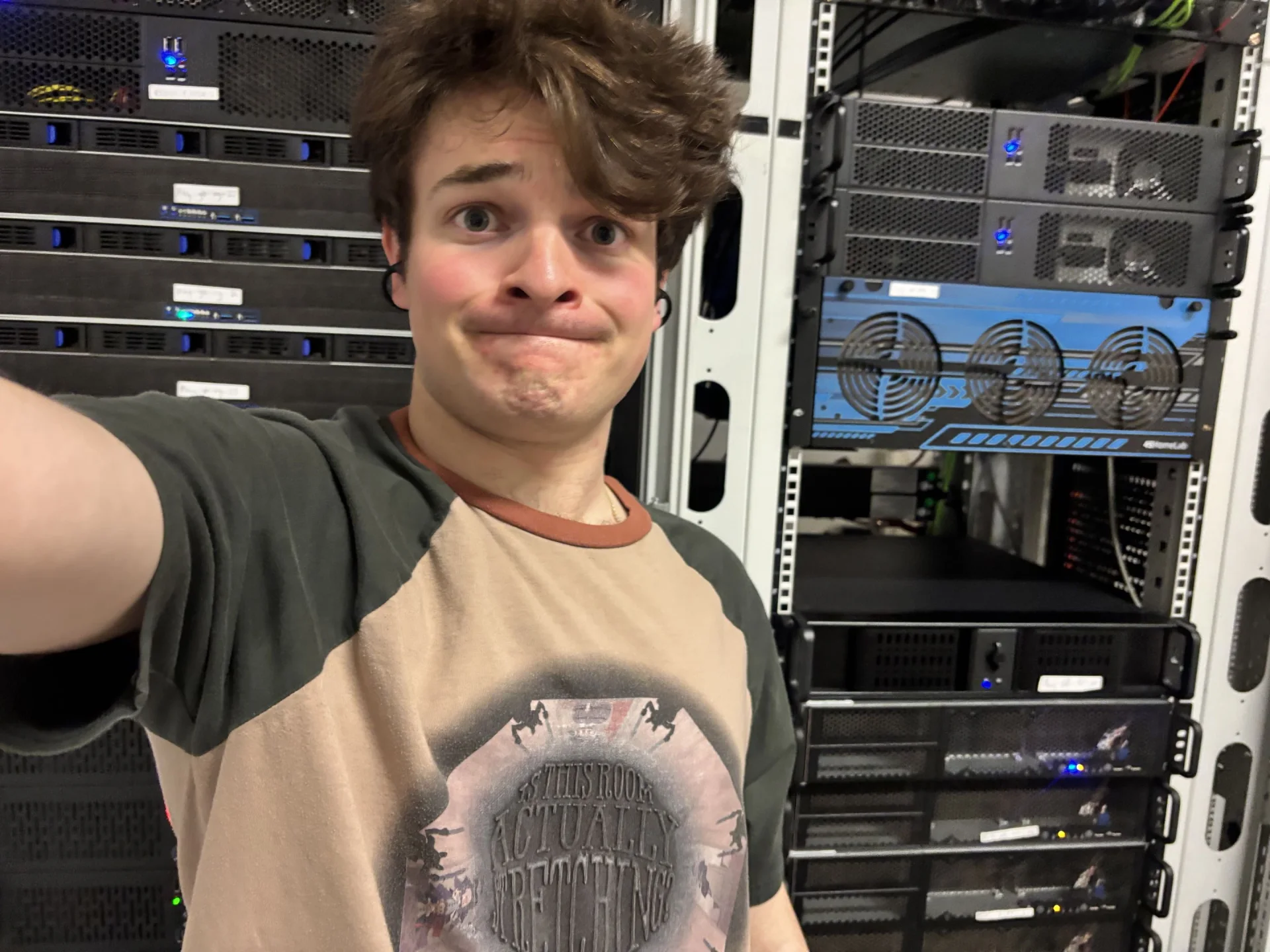 A person standing in front of Play Hosting server racks